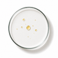 Glass plate with gold droplets on a white background