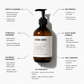 An amber glass pump bottle labeled 'JUÖDA KÖPA' centered on a light gray background, surrounded by callout lines and text describing product benefits such as gentle cleansing, skin-friendly formula, plant-based ingredients, and luxurious fragrance.